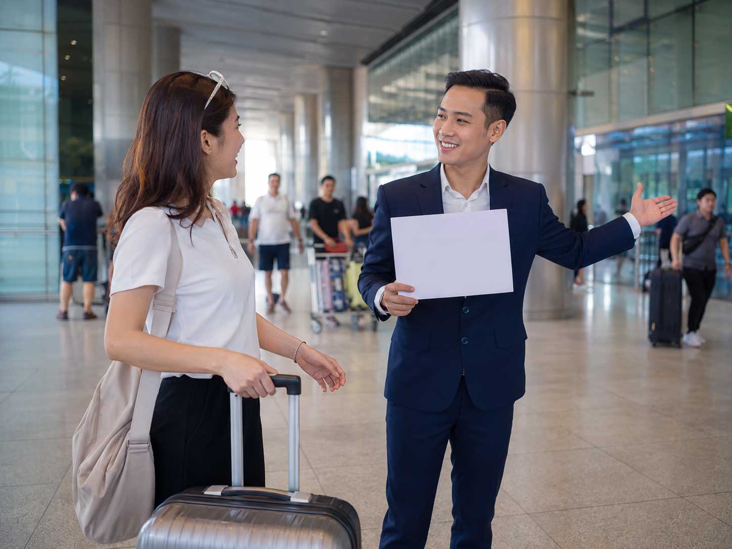 Fast-Track Vietnam team welcoming a traveller at a modern airport terminal